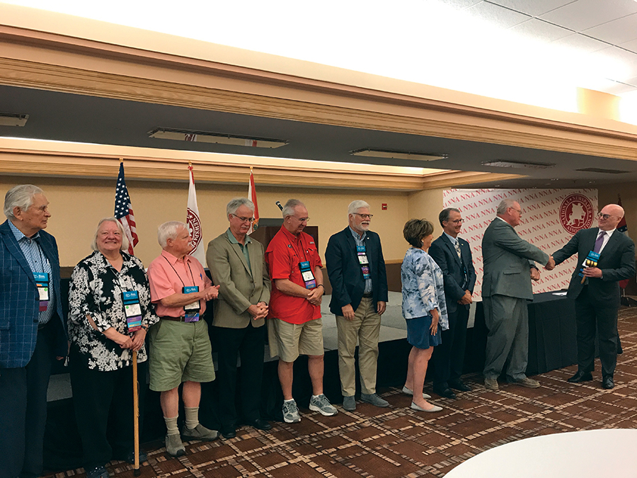 NNA past presidents pass the gavel — L to R: Eugene Johnson, Press Publications, White Bear Lake, Minnesota; Diane Everson, The Edgerton (Wisconsin) Reporter; Steven Haynes, Haynes Publishing, Oberlin, Kansas; Reed Anfinson, Swift County Monitor-News, Benson, Minnesota; Robert M. Williams Jr., NNA director of creative resources, Blackshear, Georgia; Matthew Paxton, The News-Gazette, Lexington, Virginia; Susan Rowell, retired, Lancaster, South Carolina; Andrew Johnson, retired, Horicon, Wisconsin; Matthew Adelman, Douglas (Wyoming) Budget; Brett Wesner, Wesner Publications, Cordell, Oklahoma. NNA past presidents pass the gavel — L to R: Eugene Johnson, Press Publications, White Bear Lake, Minnesota; Diane Everson, The Edgerton (Wisconsin) Reporter; Steven Haynes, Haynes Publishing, Oberlin, Kansas; Reed Anfinson, Swift County Monitor-News, Benson, Minnesota; Robert M. Williams Jr., NNA director of creative resources, Blackshear, Georgia; Matthew Paxton, The News-Gazette, Lexington, Virginia; Susan Rowell, retired, Lancaster, South Carolina; Andrew Johnson, retired, Horicon, Wisconsin; Matthew Adelman, Douglas (Wyoming) Budget; Brett Wesner, Wesner Publications, Cordell, Oklahoma.