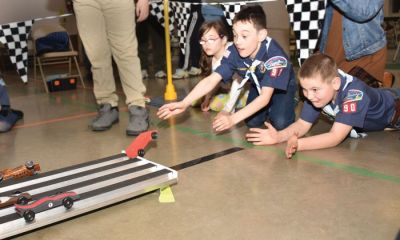 Saturday night at the track — Nearly 30 members of Centralia Boy Scout Troop 90 and Centralia Cub Scout Pack 90 packed into the gym at the Centralia First Baptist Church the evening of Saturday, Feb. 26 and raced nearly two-dozen hand-carved wooden cars down a 50-foot aluminum track for the organizations’ annual Pinewood Derby. Shown above, from the left, are Ashlee Adams, Daniel Adams and Garon Stowers eagerly watching their cars come to crashing conclusions at the finish line. (James Smith | Centralia (Missouri) Fireside Guard) Saturday night at the track — Nearly 30 members of Centralia Boy Scout Troop 90 and Centralia Cub Scout Pack 90 packed into the gym at the Centralia First Baptist Church the evening of Saturday, Feb. 26 and raced nearly two-dozen hand-carved wooden cars down a 50-foot aluminum track for the organizations’ annual Pinewood Derby. Shown above, from the left, are Ashlee Adams, Daniel Adams and Garon Stowers eagerly watching their cars come to crashing conclusions at the finish line. (James Smith | Centralia (Missouri) Fireside Guard)
