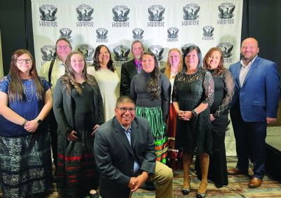 Cherokee Phoenix staff at the newspaper’s Dec. 10 Seven Feathers Awards Gala, honoring Cherokees who work to make the world a better place in the categories of business, community, education, health and service, and work that advances the tribe’s culture and language. Kneeling: Will Chavez. Front row: Terris Howard, Samantha Cochran, Lindsey Bark and Carmellita Vann, Back row: D. Sean Rowley, Dena Tucker, Chad Hunter, Stacie Boston, Joy Rollice and Tyler Thomas. Not pictured: 
Mark Dreadfulwater.