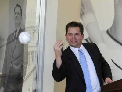 Rex Rust, co-president of Rust Communications, tosses the ball to his brother, Gary II, during the dedication and open house of Southeast Missouri State University s new Rust Center for Media on Oct. 7, 2016. (Southeast Missourian)