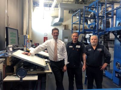 Argus-Press Publisher Tom Campbell, left, along with press operators Scott Carroll and Bill McMann use NewsWayX to monitor page and plate production from the pressroom in Owosso, Michigan.  With the cloud based system, the three can keep an eye on the workflow on their phones when they’re between shifts on the weekends.  No more coming into work too early for the Friday and Saturday night press runs when late sports coverage pushes back the deadline.