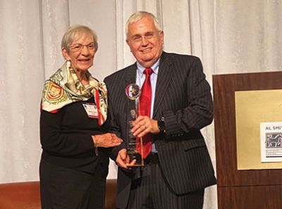 Martha Helen Smith, widow of Al Smith, shares the stage with Al Cross as he is awarded with the Al Smith Polaris Award. (Pat Host)