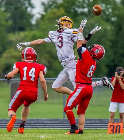 ACROBATIC CATCH - Edgerton wide receiver Scottie Krontz goes up to catch a pass over the top of two Hilltop defensive backs. (Date of publication: August 30, 2023) (Rich Harding, The Village Reporter, Montpelier, Ohio) ACROBATIC CATCH - Edgerton wide receiver Scottie Krontz goes up to catch a pass over the top of two Hilltop defensive backs. (Date of publication: August 30, 2023) (Rich Harding, The Village Reporter, Montpelier, Ohio)