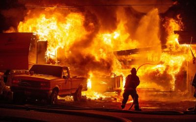 NEWS: A Wenatchee Valley Firefighter begins an attack on a fire that engulfs a fifth wheel trailer, truck, and damages two houses at the northwest corner of 13th Street Northeast and Clements Circle in East Wenatchee Sunday night, April 30, 2023, at about 9:30. (Don Seabrook | The Wenatchee (Washington) World) NEWS: A Wenatchee Valley Firefighter begins an attack on a fire that engulfs a fifth wheel trailer, truck, and damages two houses at the northwest corner of 13th Street Northeast and Clements Circle in East Wenatchee Sunday night, April 30, 2023, at about 9:30. (Don Seabrook | The Wenatchee (Washington) World)